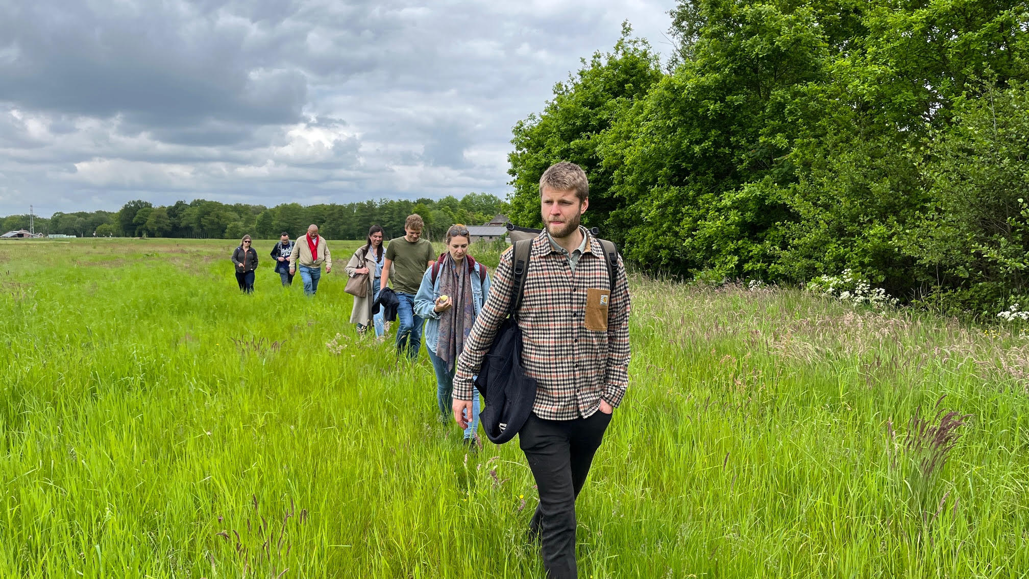 Groep mensen wandelt over de Veluwe.